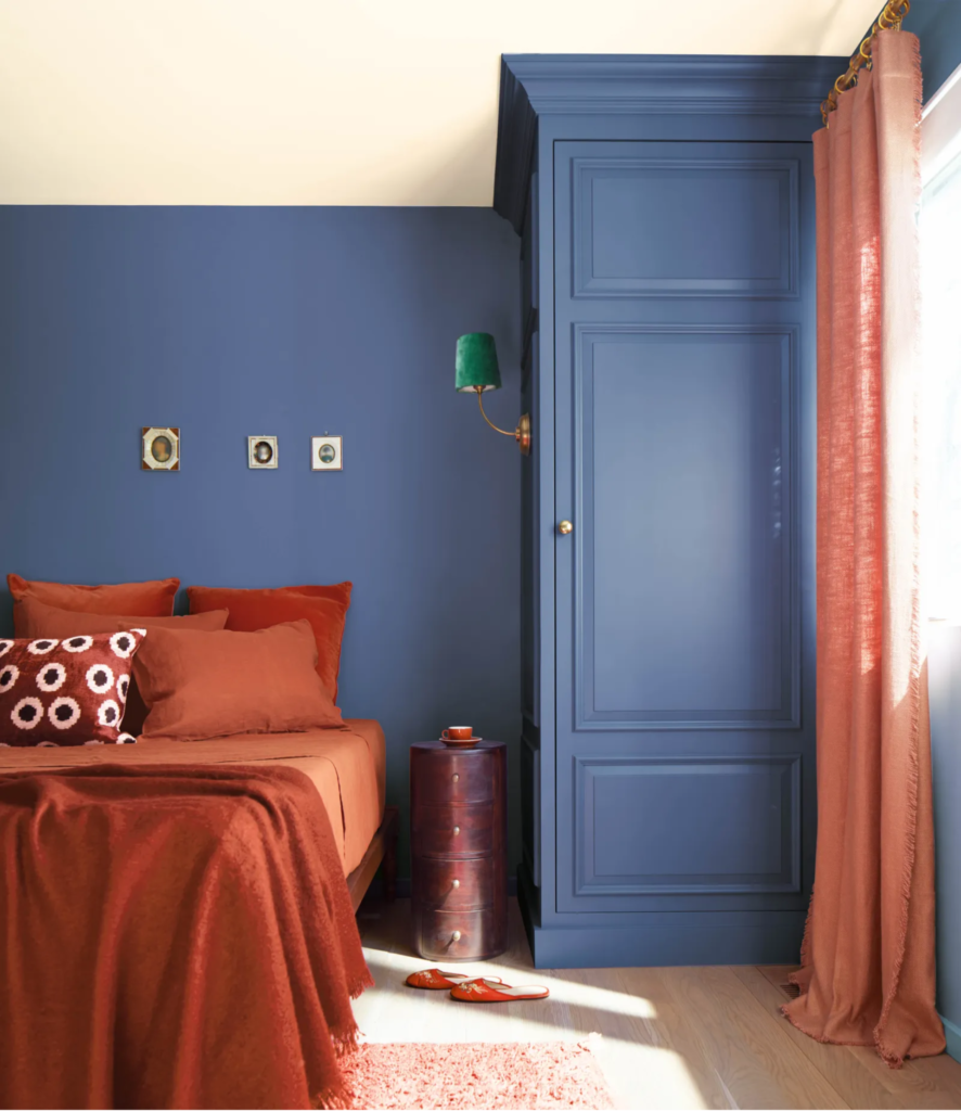 Benjamin Moore Nova Blue color of the year on wall in bedroom.