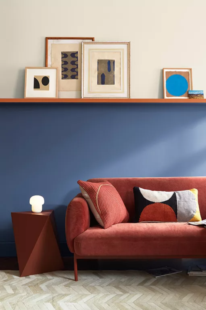 Living room with half wall painted in Benjamin Moore Nova Blue color of the year.